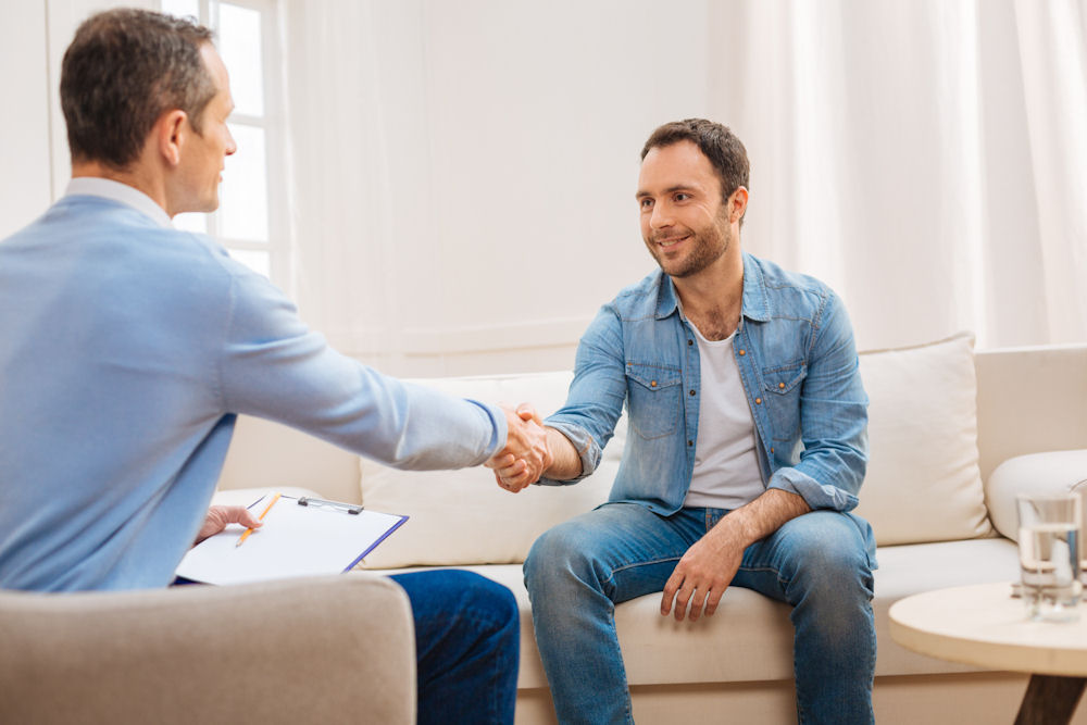 a-man-shaking-hands-with-his-therapist-in-therapy